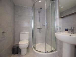 a bathroom with a shower and a toilet and a sink at 1 Bed in Seahouses oc-cn123 in Seahouses +3 photos