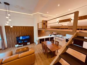 a bedroom with a bunk bed and a living room at Khao Lak - Loft Suite with 2 king size beds, bathroom with bathtub in Khao Lak