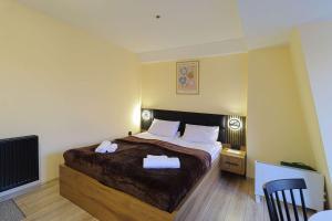 a bedroom with a bed with two towels on it at Comfy Studio in Gudauri Marshall - By Wehost in Gudauri