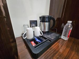 a tray with a coffee maker on top of a table at Hotel Sai Paradise in Lucknow