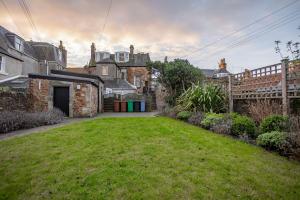 a yard with a lawn in front of some buildings at Overton - Elie in Elie