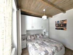 a bedroom with a bed and a wooden ceiling at Moda Apartments G1 in Sestriere
