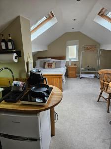 a bedroom with a bed and a desk in a room at The Attic in Dove Holes