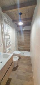 a bathroom with a toilet and a sink and a shower at Moda Apartments G1 in Sestriere +6 photos