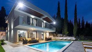 a villa with a swimming pool at night at Villa Juma by Villas Guide in Blace