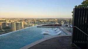 a swimming pool on top of a building at FV 1BR APT with Rooftop Pool in Brisbane +18 photos