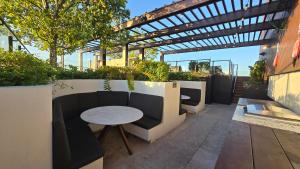 a patio with a couch and a table on a building at FV 1BR APT with Rooftop Pool in Brisbane