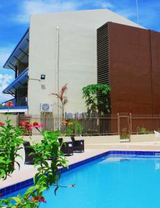a swimming pool in front of a building at Nambis Inn in Madang