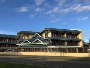 a large apartment building with a building at Nambis Inn in Madang