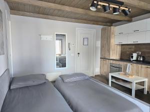 a bedroom with two beds and a table in it at Moda Apartments G1 in Sestriere