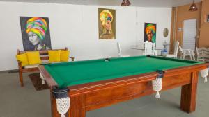a room with a pool table in a room with ahibition at Pousada Sal e Mar Maracaipe in Porto De Galinhas