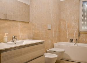 a bathroom with a sink and a toilet and a tub at Velaria Boutique Apartment in Monopoli +28 photos