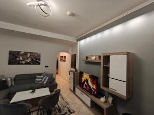 a living room with a couch and a tv at Xryspa suites in Ioannina +14 photos