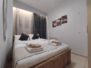 a bedroom with two beds with towels on them at Xryspa suites in Ioannina