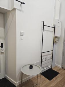 a table in a room with a white wall at Le Ptit nid in Château-Gontier +26 photos