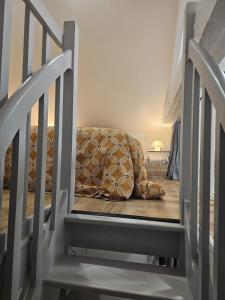 a chair sitting on the floor next to a staircase at Le Ptit nid in Château-Gontier