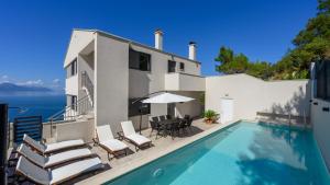 a villa with a swimming pool and a house at Villa Dida Bozo by Villas Guide in Blace