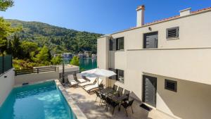 a swimming pool on the balcony of a building at Villa Dida Bozo by Villas Guide in Blace