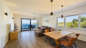 a living room with a table and a couch at Villa Dida Bozo by Villas Guide in Blace