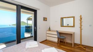 a bedroom with a bed and a desk with a mirror at Villa Dida Bozo by Villas Guide in Blace +34 photos
