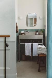 a bathroom with a sink and a mirror at HOY Paris - Yoga Hotel in Paris +43 photos