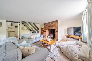 a living room with a couch and a fireplace at Mill View in Harpley