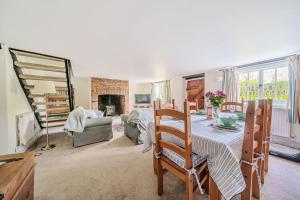 a living room with a table and a fireplace at Mill View in Harpley