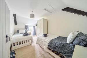 a bedroom with two beds and a window at Mill View in Harpley