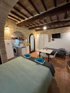 a room with a bed and a table and a kitchen at Casa Leon - City center in Perugia