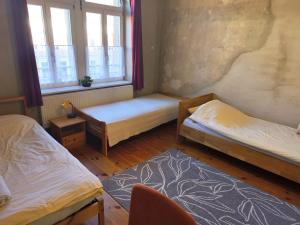 a room with two beds and a window at Grosses Privatzimmer mit Altbau-Charme in Leipzig