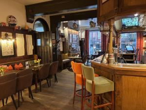 a restaurant with tables and chairs and a bar at Great Malvern Hotel in Great Malvern +6 photos