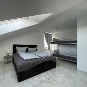 a bedroom with a bed and two bunk beds at Sunshine FeWo in Rust