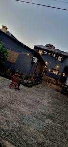 a blue building with a bench in front of it at Hostel Barato Zona Sul in Porto Alegre