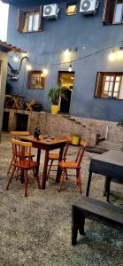 a wooden table and chairs in front of a building at Hostel Barato Zona Sul in Porto Alegre