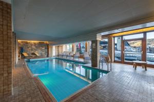 a swimming pool in a hotel with a view at Hotel Austria Wildschönau & Wildschönau Premium Card in Niederau