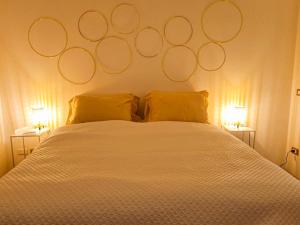 a bedroom with a white bed with circles on the wall at Casa Azzurra in Pizzo