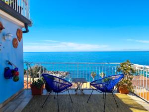 a balcony with two chairs and a view of the ocean at Casa Azzurra in Pizzo