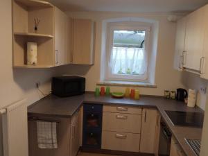 a small kitchen with a sink and a window at Ferienhaus Koenig in Kulmain