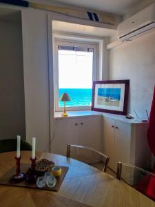 a dining room table with a view of the ocean at Casa Azzurra in Pizzo +24 photos