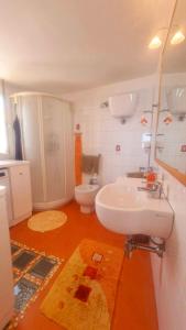 a bathroom with a white sink and a toilet at Casa Azzurra in Pizzo