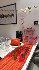 a table with a cake and cups on it at Hoxne Cottages in York