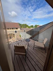 a balcony with a table and a chair and a table at EBURON estate Boutique B&B in Diets-Heur