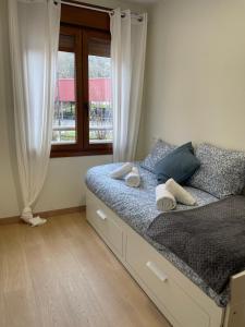 a bed in a bedroom with a window at JayjAstur in Cangas de Onís +36 photos