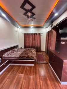 a bedroom with a bed and a ceiling at Mount view guest house in Mukteshwar