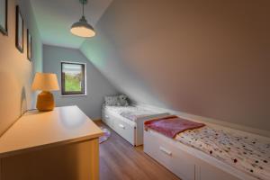 En eller flere senge i et værelse på Siedlisko Pierszczewko