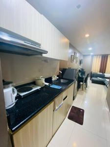 a kitchen with a counter top and a stove at The Highland Condotel in Baguio