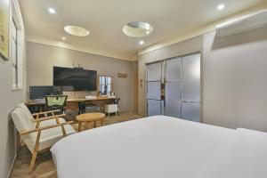 a room with a bed and a desk with a computer at Palace Hotel in Ulsan +48 photos