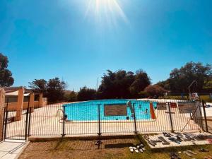 a swimming pool with a fence around it at Maison en corse in Santa-Maria-Poggio +7 photos