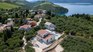 an aerial view of a house on a hill next to a lake at Villa Olea by Villas Guide in Blace