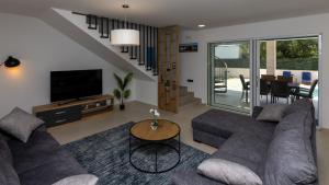 a living room with a couch and a table at Villa Olea by Villas Guide in Blace